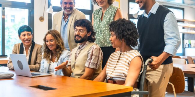 Diverse corporate team collaborating in inclusive coworking office
